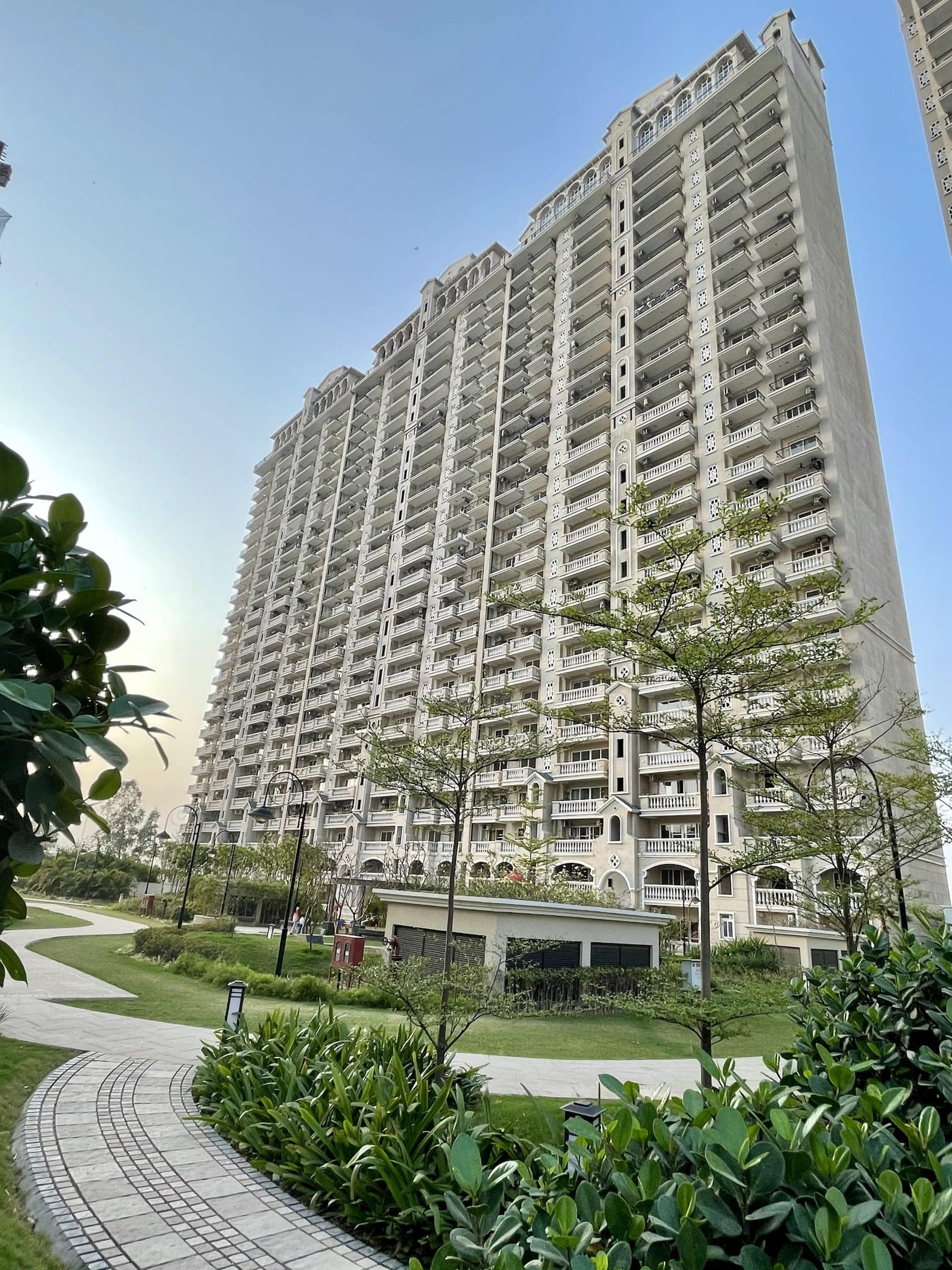 Photograph of a completed ATS Casa Espana tower seen from a garden path