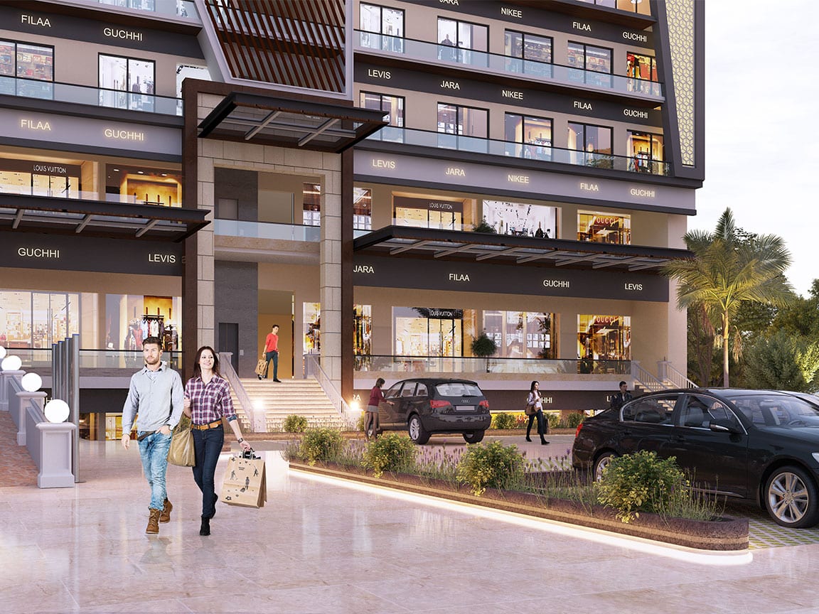 Render of the main entrance canopy and steps at Aster Plaza, Zirakpur, with lit ground and upper-ground showrooms, a landscaped planter and shoppers in the forecourt.