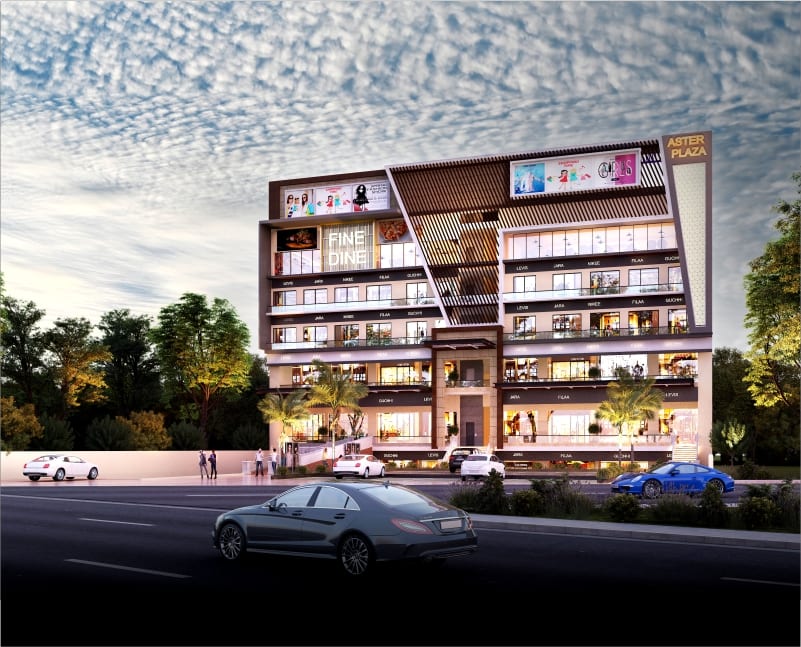 Dusk street-view render of the Aster Plaza commercial building in Zirakpur seen from the road, with trees on either side and cars in the foreground.