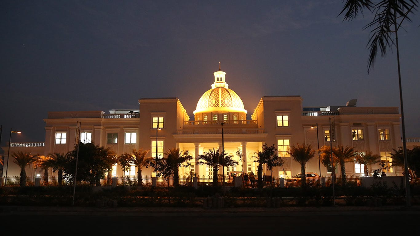 Photograph of the DLF Hyde Park City Club in Hyde Park Estate, New Chandigarh, lit up at night