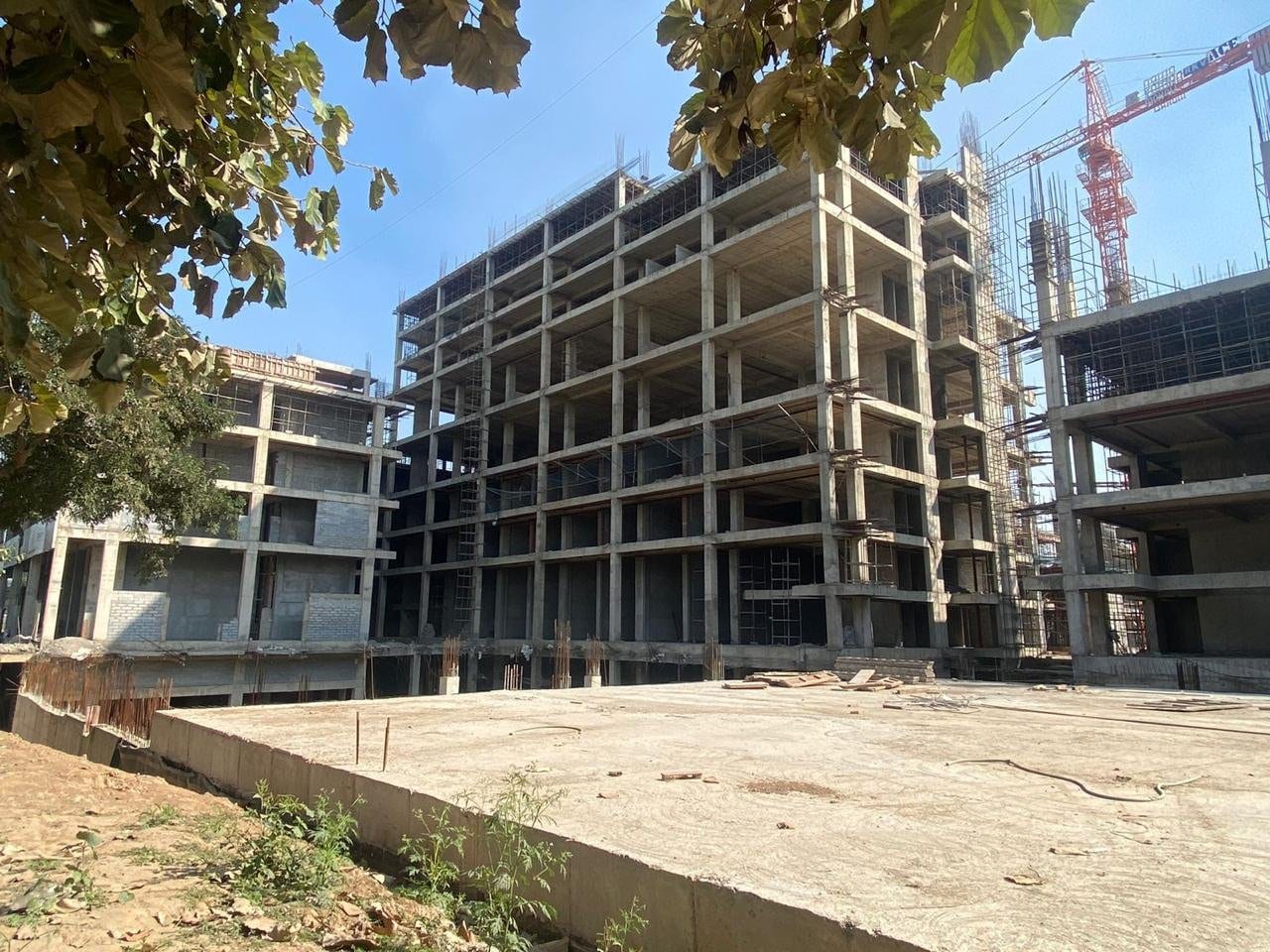Photo of Downtown Mohali, Sector 62, under construction — the RCC frames of the blocks with a tower crane behind (date not published)