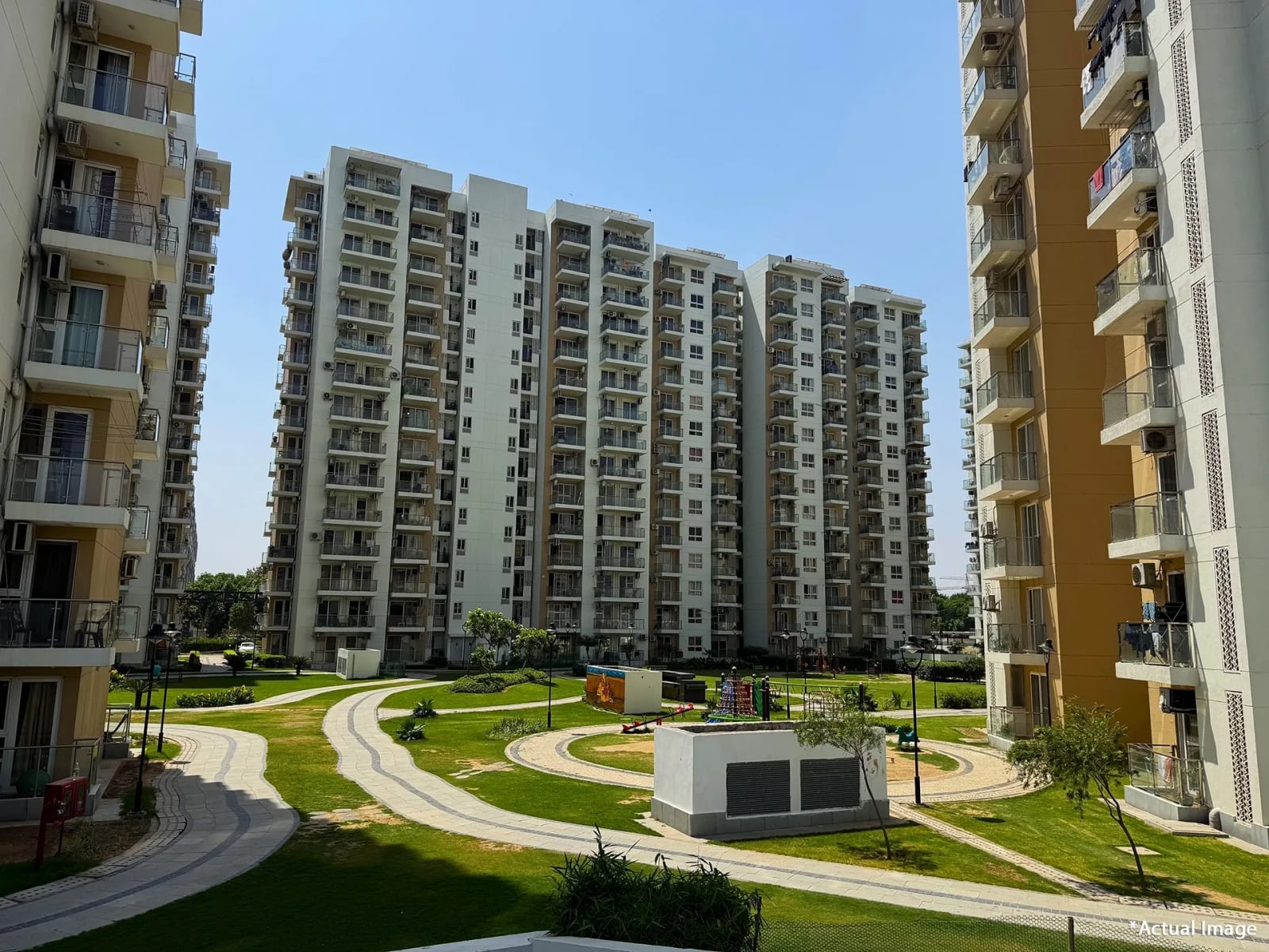 Actual photo of completed apartment towers and landscaped walkways at Hero Homes, Sector 88, Mohali
