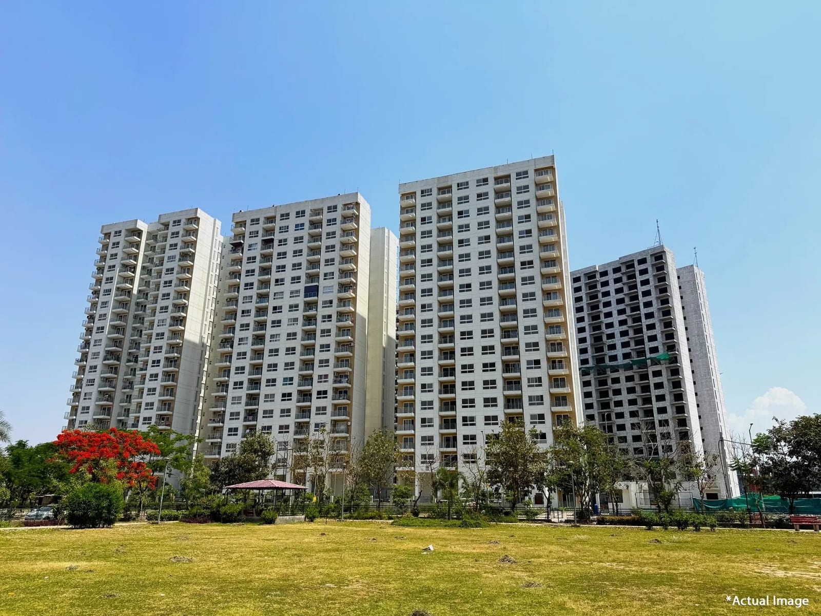 Actual photo of Phase 2 apartment towers at Hero Homes, Sector 88, Mohali, seen across an open green