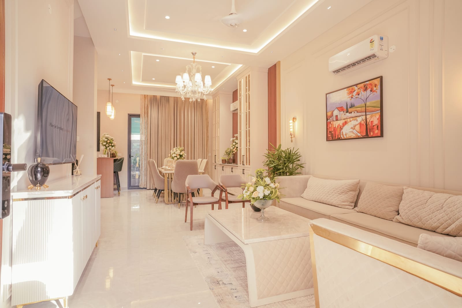 Photo of the living room in the Highland Luxuria sample villa with a chandelier and sofa set